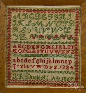 Wool on linen sampler, dated 1869, wrought by J. B. Duckett, 12 1/2'' x 11 1/4''.