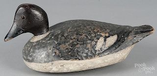 Carved and painted duck decoy, mid 20th c., with a dimpled body and fluted tail, 12 1/2'' l.