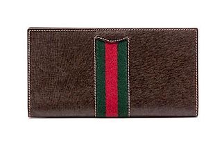 A Gucci Brown Leather Checkbook, 6.4" x 3.2".