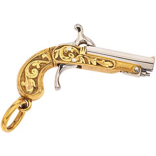 18K WHITE AND YELLOW GOLD PENDANT Pistol design with flip-top barrel and articulated trigger. 