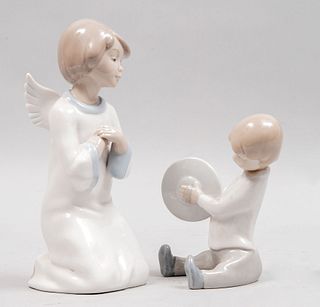 Ángel y niño con platillos. España y México, siglo XX. Elaborados en porcelana tipo Lladró y Dalia. Piezas: 2