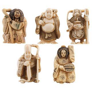 GROUP OF NETSUKE FIGURES JAPAN, EARLY 20TH CENTURY Carved in ivory with inked details Signed Includes two with mobile faces 1.9" (5 cm)