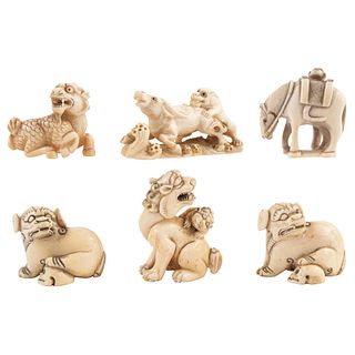 GROUP OF NETSUKE FIGURES JAPAN, EARLY 20TH CENTURY Carved in ivory Some signed Includes Fu dogs and horse 1.7" (4.5 cm)