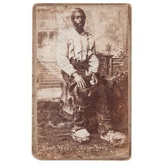 [SLAVERY & ABOLITION]. RUSSEL BROS., photographers. Boudoir card of African American "whose feet would require No. 17 shoes..." Anniston, AL, n.d. 
