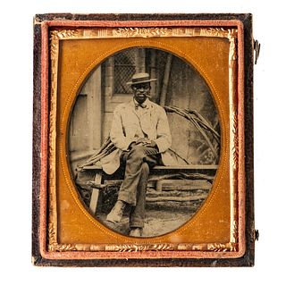 [TINTYPE - PORTRAITURE]. Sixth plate tintype of African American gentleman seated on a porch. N.p., n.d. 