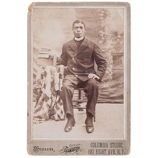 [CABINET CARD - OCCUPATIONAL]. BROWN ART STUDIO, photographer. African American Clergyman seated in a studio. New York, [ca 1910]. 