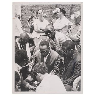 [KING, Martin Luther, Jr. (1929-1968)]. Press photograph of Dr. King leading a prayer in Philadelphia, MS, after a planned march was interrupted. Phil