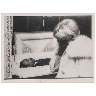 [KING, Martin Luther, Jr. (1929-1968)]. Press photograph of Dr. King lying in repose at his Memphis funeral, while woman sobs before him. Memphis, TN,