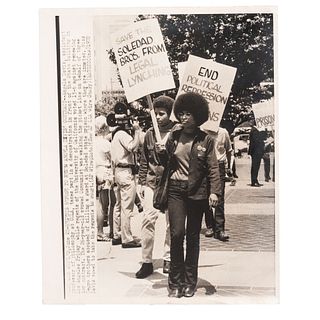 [DAVIS, Angela (b. 1944)]. Press photograph of Davis leading march for the Soledad Brothers in front of the State building in Los Angeles, while regen