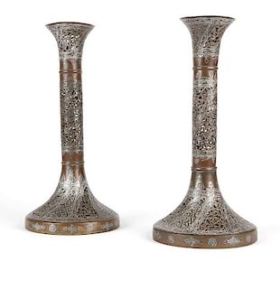A pair of Indo Persian mixed metal candle holders