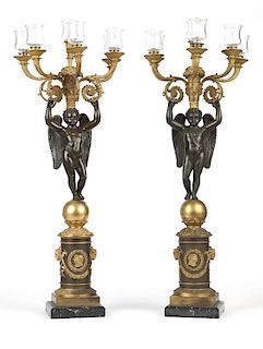 A pair of Empire style gilt & patinated bronze candelabra
