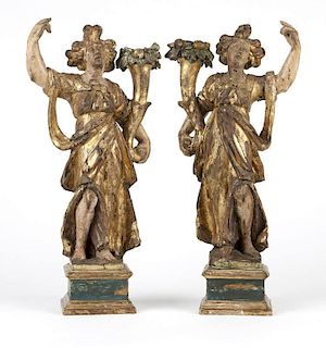 A pair of Italian polychromed & gilt carved pine candelabra