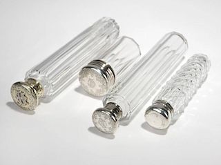 Four sterling silver-mounted glass bottles