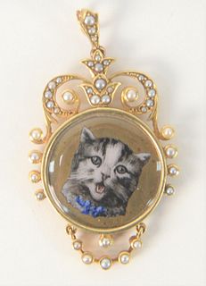 15 Karat Gold Medallion, with enameled cat, set with small pearls, height 1 7/8 inches, total weight 13.8 grams.