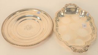 Two Sterling Silver Low Dishes, one with two handles, length 14 1/2 inches, diameter 11 1/2 inches, 32.2 t.oz. Provenance: The Estate of Gloria Schiff