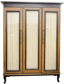 Large Bausman and Company Three-Door Cabinet, having leather and tac, framed glass doors and shelves on interior, height 102 inches, width 78 inches, 