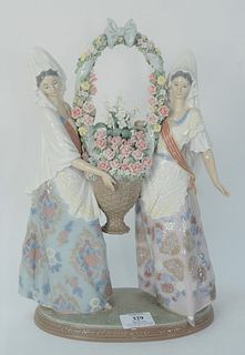 Large Lladro Porcelain Figure, two women holding a flower basket, signed on the underside 'I. Huertas' and 'V. Navarro', No. 132, height 15 inches.