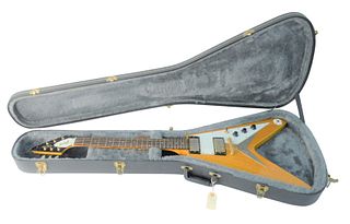 1998 Epiphone '58 Flying V Reissle Guitar, serial #U98071377, Korina Natural finish, original hard-shell case, length 45 inches.
