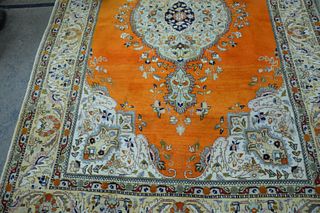 Two Room Size Carpets, to include Oriental with orange ground, 6' 8" x 10'; along with light tan, custom carpet, 8' x 10' 6". Provenance: From the Rob