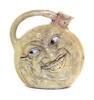 A Martin Brothers Salt Glazed Stoneware Face Jug Height 9 1/2 inches.