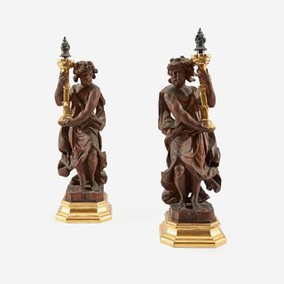 A Pair of Italian Silver-Mounted Parcel-Gilt Walnut Figural Torchères, 18th century and later