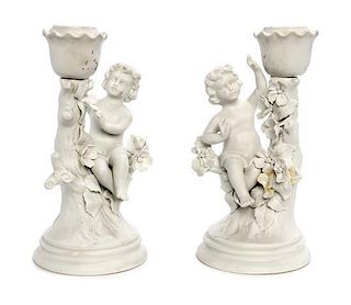 * A Pair of Bisque Porcelain Figural Candlesticks Height 7 1/4 inches.