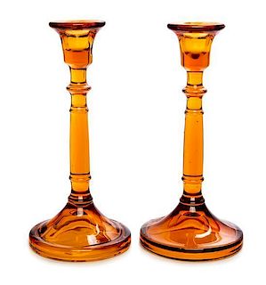 * A Pair of Amber Glass Candlesticks Height 8 3/4 inches.