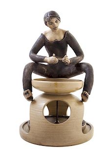 * Guy Sydenham, (British, 1916-2005), A Poole Potter Seated at a Wheel, c. 1970