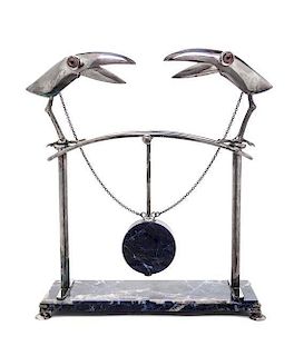 A Continental Silver and Marble Sculpture, 1989, depicting two stylized toucans joined by chains to a central pendulum, on a rec