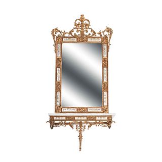 Mesa consola con espejo (coqueta) Siglo XX. Fundición en bronce dorado. Con luna rectangular biselada y cubierta de mármol.