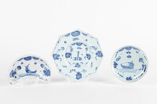 Three white and blue ceramic saucers