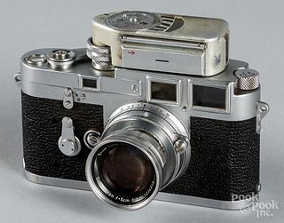 Leica M3 camera with light meter and lens.