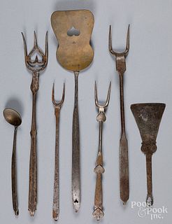 Reproduction wrought iron and brass utensils.