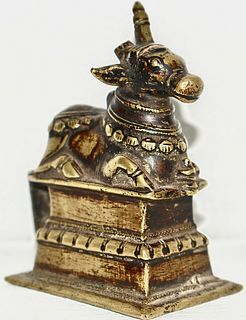 A brass sitting Nandi ( Cow ) with Jewellery 