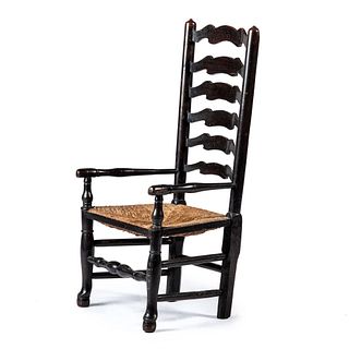 A William and Mary Black-Stained Ladder Back Rush-Seat Armchair