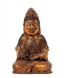 A Chinese Gilt and Black Lacquered Bronze Figure of Avalokitesvara MING DYNASTY Height 10 1/2 x width 6 3/4 inches.