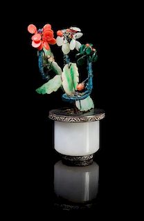 A Chinese Jadeite Archer’s Ring Mounted as Hardstone Flower Tree 19TH/20TH CENTURY Height 3 7/8 inches.