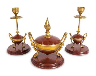 A Napoleon III Gilt Bronze and Rouge Marble Three-Piece Desk Set
Height of urn, 6 1/2, candlestics, 7 1/2 inches.