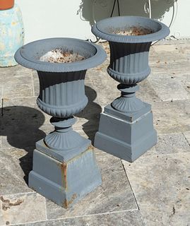 A Pair of Cast Iron Campana-form Jardinieres on Pedestals
Height 27 x diameter 15 inches.