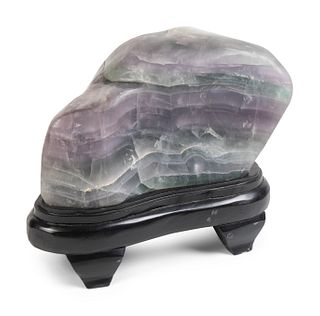 A Chinese Lavender and Green Quartz Boulder
Height 8 1/2 x length 15 1/2 x width 8 1/2 inches; Height of stand 5 x length 16 x depth 10 inches.
