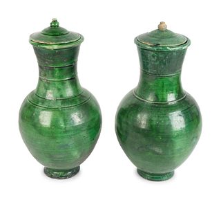 A Pair of Chinese Green-Glazed Terracotta Lidded Hu-Form Jars
Height 14 1/2 x diameter 7 inches.
