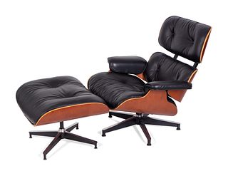 An Eames Laminated Walnut and Black Leather Lounge and Ottoman
Height 33 1/2 x width 32 x depth 32 inches; height of ottoman 17 x width 26 x depth 22 