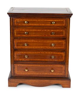 A George III Style Inlaid Mahogany Miniature Chest of Drawers
Height 18 1/4 x width 15 1/2 x depth 9 1/2 inches.