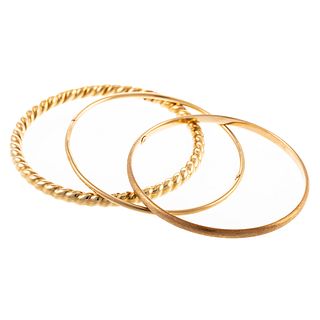A Collection of Three Bangles in 14K Yellow Gold
