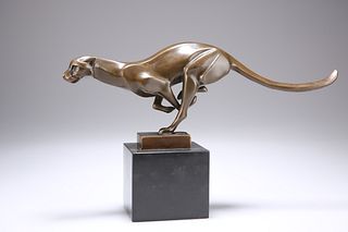 AN ART DECO STYLE BRONZE MODEL OF A PANTHER, cast in a runn