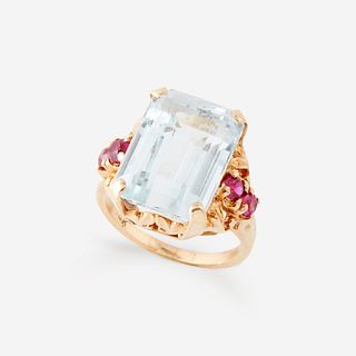 An aquamarine, ruby, and fourteen karat gold ring,