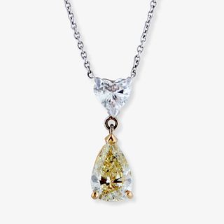 A fancy light yellow diamond, colorless diamond and fourteen karat bi-color gold pendant necklace,