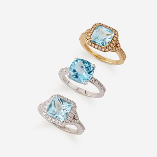 A collection of three blue topaz, diamond, and eighteen karat gold rings,