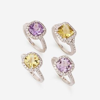 A collection of four quartz, diamond, and eighteen karat white gold rings,