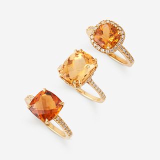 A collection of three citrine, diamond, and eighteen karat gold rings,